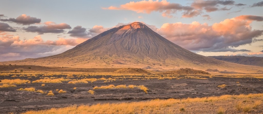 Ol Doinyo Lengai volcano illuminated by warm sunset light
